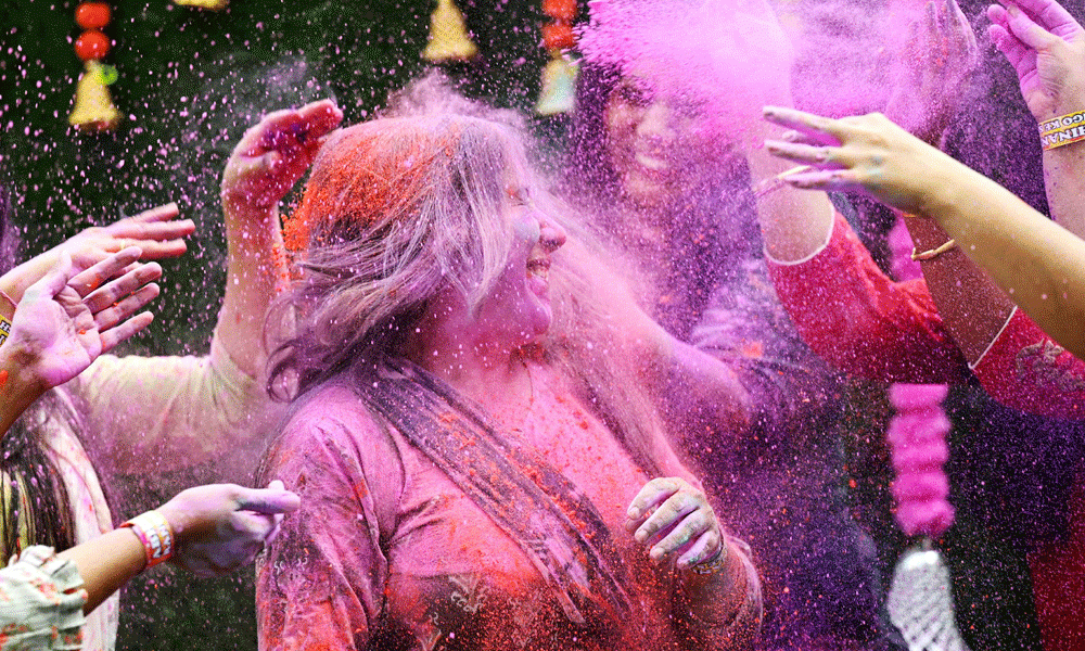 Women smeared with ‘Gulal' as they celebrate Holi, the Hindu spring festival of colours, in Chennai on March 25, 2024. Photo : AFP