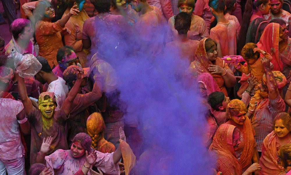 People smeared with ‘Gulal' as they celebrate Holi, the Hindu spring festival of colours, in Hyderabad on March 25, 2024. Photo : AFP