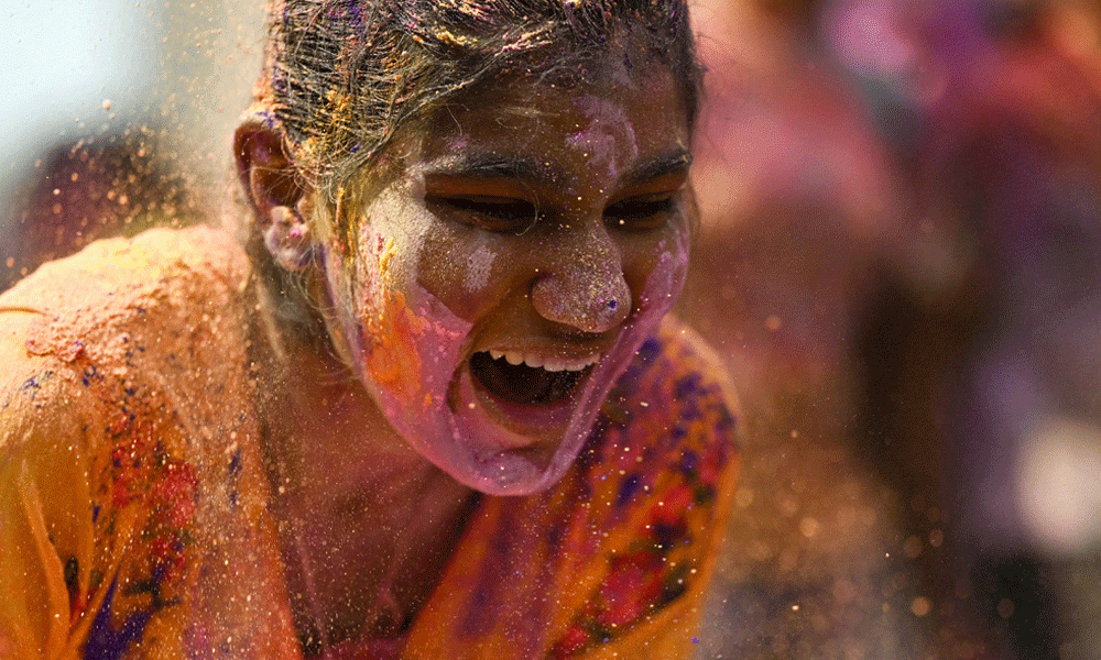 A girl is smeared with ‘Gulal' as she celebrates Holi, the Hindu spring festival of colours, in Chennai on March 25, 2024. Photo : AFP