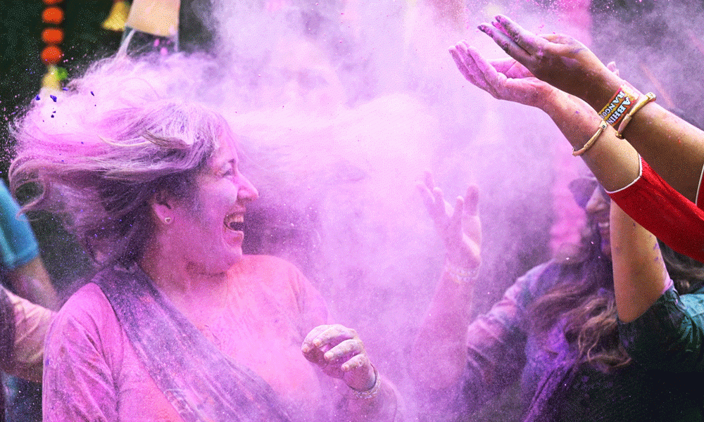 Women smeared with ‘Gulal' as they celebrate Holi, the Hindu spring festival of colours, in Chennai on March 25, 2024. Photo : AFP